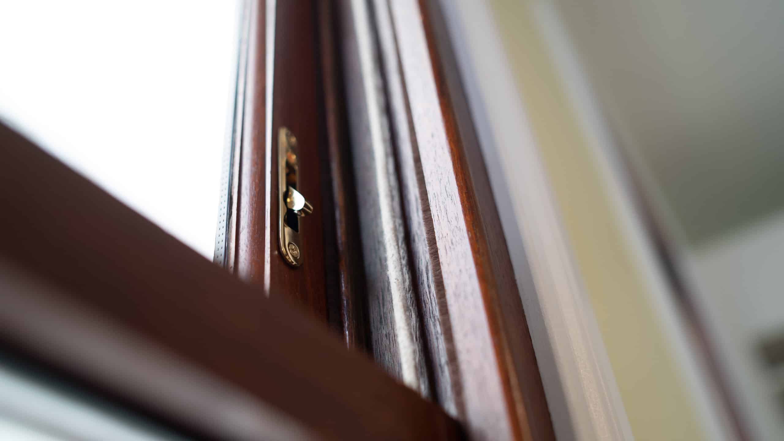 A close up view of a wooden window frame with latch